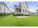 Expansive backyard featuring a screened porch, patio, and lush green lawn at 733 Daniel Ridge Rd, Wendell, NC 27591