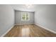 Bright bedroom featuring hardwood floors, natural light, and neutral walls at 733 Daniel Ridge Rd, Wendell, NC 27591