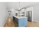 Kitchen showcasing the island with quartz countertops, stainless steel appliances, and custom cabinetry at 733 Daniel Ridge Rd, Wendell, NC 27591