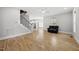 Open-concept living area with hardwood floors, a staircase, and view of the kitchen and dining area at 733 Daniel Ridge Rd, Wendell, NC 27591