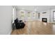 Cozy living room features hardwood floors, a fireplace, large windows, and a modern ceiling fan at 733 Daniel Ridge Rd, Wendell, NC 27591