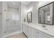 Main bathroom featuring double sinks, a tiled shower and neutral paint scheme at 733 Daniel Ridge Rd, Wendell, NC 27591