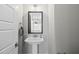Stylish powder room with pedestal sink, framed mirror, and neutral paint scheme at 733 Daniel Ridge Rd, Wendell, NC 27591