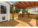 Outdoor wooden deck featuring a pergola with covering, ideal for entertaining and relaxation at 741 Rockville Rd, Wake Forest, NC 27587