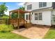 Charming backyard featuring a brick patio, wood deck with pergola, and well-maintained lawn perfect for outdoor living at 741 Rockville Rd, Wake Forest, NC 27587