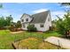 Backyard featuring a wooden deck, well-maintained garden, and partial privacy fence at 741 Rockville Rd, Wake Forest, NC 27587