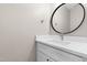 Stylish bathroom features a white vanity, quartz countertop, modern sink and a round mirror at 741 Rockville Rd, Wake Forest, NC 27587