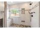 Stylish walk-in shower with stone floor, rainfall shower head, and mosaic tile accents at 741 Rockville Rd, Wake Forest, NC 27587