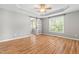 Spacious bedroom with hardwood floors, ceiling fan, large window, and ensuite bathroom at 741 Rockville Rd, Wake Forest, NC 27587