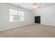 Bright bedroom with neutral carpeting, dormer window, and ceiling fan at 741 Rockville Rd, Wake Forest, NC 27587