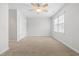 Spacious bedroom with neutral carpeting, a ceiling fan and a double door closet at 741 Rockville Rd, Wake Forest, NC 27587