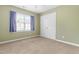 Comfortable bedroom featuring a window, carpeted floors and a double door closet at 741 Rockville Rd, Wake Forest, NC 27587
