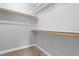 Walk-in closet with built-in shelving and ample storage space on neutral carpeting at 741 Rockville Rd, Wake Forest, NC 27587