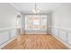 Bright dining room featuring a chandelier, large windows, and wood floors at 741 Rockville Rd, Wake Forest, NC 27587