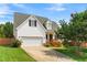Charming two-story home featuring an attached garage, well-maintained lawn, and inviting front porch at 741 Rockville Rd, Wake Forest, NC 27587