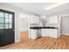 Well-lit kitchen with white cabinets, stainless steel appliances, and a black granite countertop at 741 Rockville Rd, Wake Forest, NC 27587
