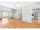 Expansive living area flows into the kitchen, featuring hardwood floors, ample lighting, and versatile layout options at 741 Rockville Rd, Wake Forest, NC 27587