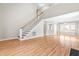 Open-concept living space showcasing hardwood floors, a staircase, and seamless flow into dining and kitchen areas at 741 Rockville Rd, Wake Forest, NC 27587