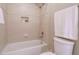 Bright bathroom featuring a tub with tile surround and built-in shelving at 8504 Carlton Oaks Dr, Wake Forest, NC 27587