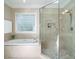 Bathroom featuring a soaking tub and a large glass shower at 8504 Carlton Oaks Dr, Wake Forest, NC 27587