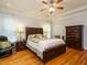 Bright bedroom with a tray ceiling, ceiling fan, and hardwood floors at 8504 Carlton Oaks Dr, Wake Forest, NC 27587