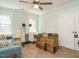 Bedroom includes a ceiling fan, light green walls, two windows, and boxes on the floor at 8504 Carlton Oaks Dr, Wake Forest, NC 27587
