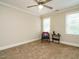 Bedroom features neutral walls, carpet, trim and a chair next to a small table at 8504 Carlton Oaks Dr, Wake Forest, NC 27587