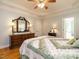 Bedroom with a tray ceiling, a large mirror, and hardwood floors at 8504 Carlton Oaks Dr, Wake Forest, NC 27587