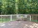 Wooden deck featuring outdoor seating and a view of a large, wooded backyard at 8504 Carlton Oaks Dr, Wake Forest, NC 27587