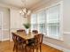 Light-filled dining room featuring a wooden table, chandelier, and a large window at 8504 Carlton Oaks Dr, Wake Forest, NC 27587