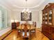 Dining room featuring a wooden table, chandelier, and a wooden china cabinet at 8504 Carlton Oaks Dr, Wake Forest, NC 27587