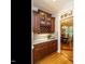 Dining area features cherry cabinets with granite counters, a wine rack, and a view into a formal dining space at 8504 Carlton Oaks Dr, Wake Forest, NC 27587