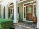 Inviting front porch with stone steps, rocking chairs, and decorative wooden door at 8504 Carlton Oaks Dr, Wake Forest, NC 27587