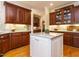 Elegant kitchen with cherry cabinets, granite countertops, stainless steel appliances, and a white kitchen island at 8504 Carlton Oaks Dr, Wake Forest, NC 27587