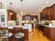 Spacious kitchen boasts custom cherry cabinets, granite countertops, stainless steel appliances, and a convenient kitchen island at 8504 Carlton Oaks Dr, Wake Forest, NC 27587