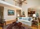 Open concept living room featuring hardwood floors, fireplace, and view of the kitchen at 8504 Carlton Oaks Dr, Wake Forest, NC 27587