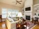 Bright living room with fireplace, built-in shelving, and large windows with natural light at 8504 Carlton Oaks Dr, Wake Forest, NC 27587