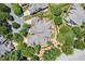 Expansive home showcasing a meticulously landscaped yard, mature trees, and a neutral toned roof at 8851 Mariner Dr, Raleigh, NC 27615