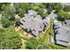 Detailed aerial view of home with mature trees, brick patio, manicured landscaping and neutral colored roof at 8851 Mariner Dr, Raleigh, NC 27615