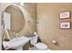 Elegant powder room featuring a decorative mirror, pedestal sink, and designer wallpaper at 8851 Mariner Dr, Raleigh, NC 27615