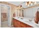 Bathroom features a double sink vanity with elegant fixtures, ample lighting and stylish decor at 8851 Mariner Dr, Raleigh, NC 27615