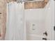Close-up of a bathtub and shower featuring white shower curtain and a bronze shower head at 8851 Mariner Dr, Raleigh, NC 27615