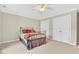 Comfortable bedroom features a ceiling fan, plush carpeting, and double door closet at 8851 Mariner Dr, Raleigh, NC 27615