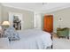 Bright bedroom with a walk-in closet, wooden armoire, and a comfortable chair near the window at 8851 Mariner Dr, Raleigh, NC 27615