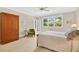 Bright bedroom with a garden view, French doors, and classic wooden furniture at 8851 Mariner Dr, Raleigh, NC 27615