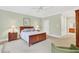 Spacious bedroom with a ceiling fan and a doorway to an attached bathroom at 8851 Mariner Dr, Raleigh, NC 27615