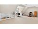 Spacious bonus room with plush carpeting, bright lighting, built in shelves and angled ceilings at 8851 Mariner Dr, Raleigh, NC 27615