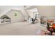 Large bonus room with plush carpeting, bright lighting, built-in shelves and angled ceilings at 8851 Mariner Dr, Raleigh, NC 27615