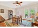 Bright breakfast area featuring a ceiling fan, hardwood floors, and large windows overlooking the backyard at 8851 Mariner Dr, Raleigh, NC 27615