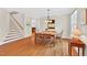Dining room with hardwood floors adjacent to staircase and windows offering natural light at 8851 Mariner Dr, Raleigh, NC 27615